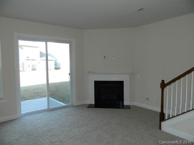 723 Falcon Ridge, Unit HKC 110 Fort Mill, SC 29708 - Photo 3 of 7 an empty room with fireplace