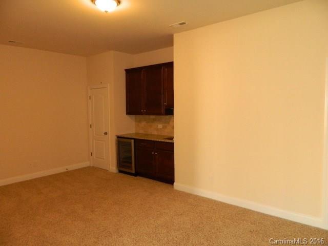 723 Falcon Ridge, Unit HKC 110 Fort Mill, SC 29708 - Photo 5 of 7 a view of an empty room with a kitchen