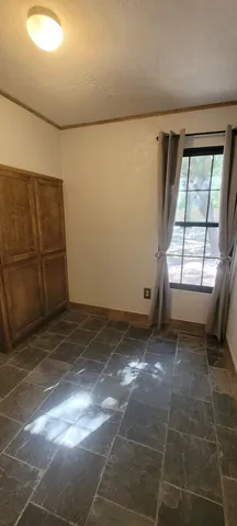 a view of a livingroom with an empty space and a window