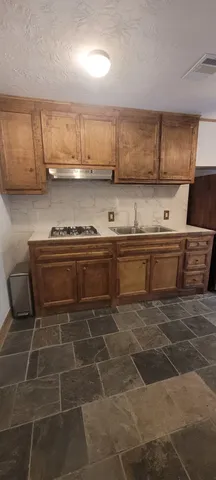 a kitchen with stainless steel appliances a stove a sink and a microwave