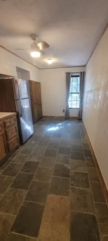 a view of a livingroom with wooden floor and a window
