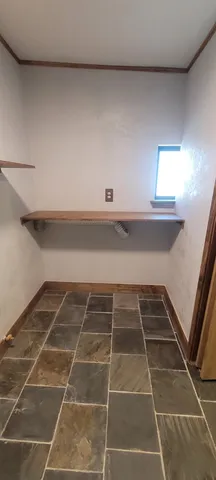 a view of a room with shelves on the wall