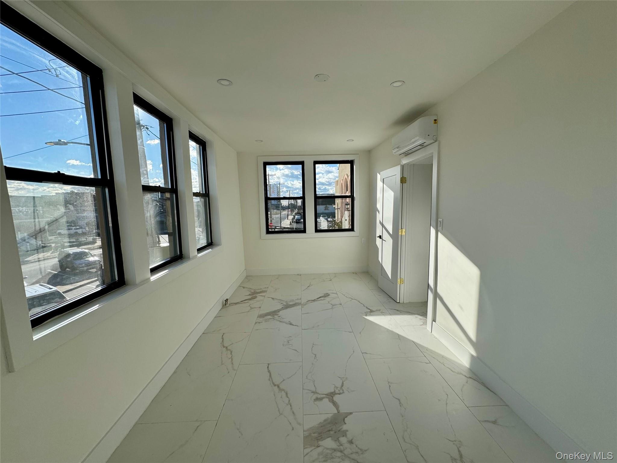 315 Riverside Boulevard, Unit 1 Long Beach, NY 11561 - Photo 6 of 9 Hall with a wall mounted AC