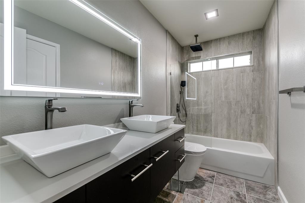 4532 Crown Ridge Drive Plano, TX 75024 - Photo 14 of 25 Dual vessel sinks with wall-mounted faucets and an illuminated mirror