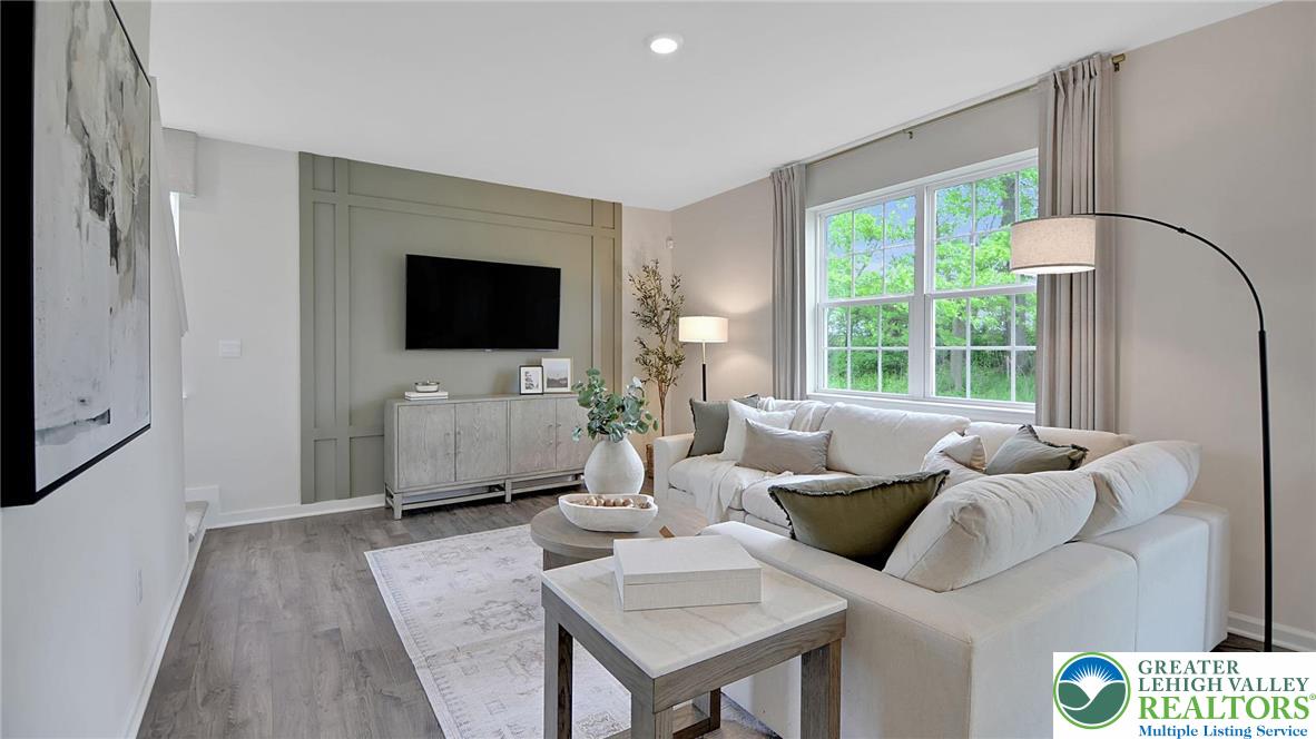 113 Winding Road Easton, PA 18040 - Photo 11 of 29 a living room with furniture a flat screen tv and a large window