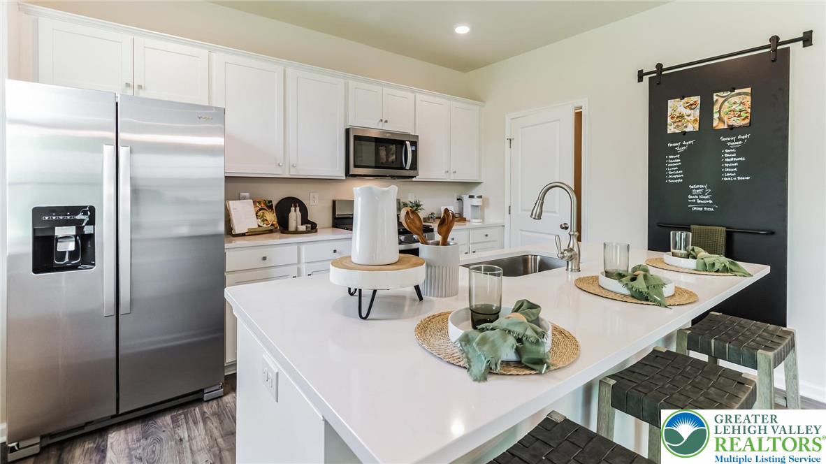 113 Winding Road Easton, PA 18040 - Photo 5 of 29 a kitchen with stainless steel appliances a refrigerator a sink a stove a table and chairs