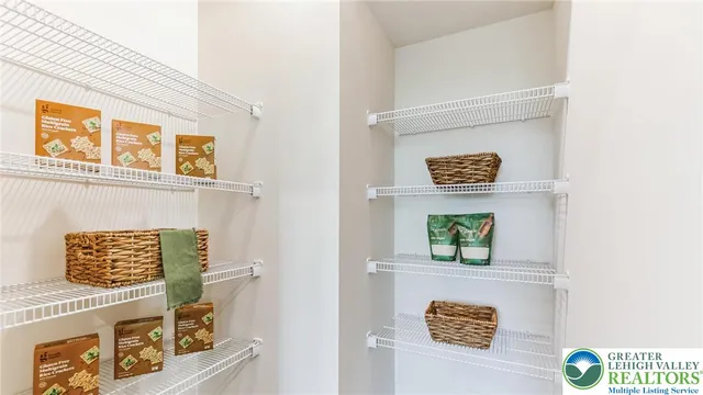 a living room with furniture a flat screen tv and a large window