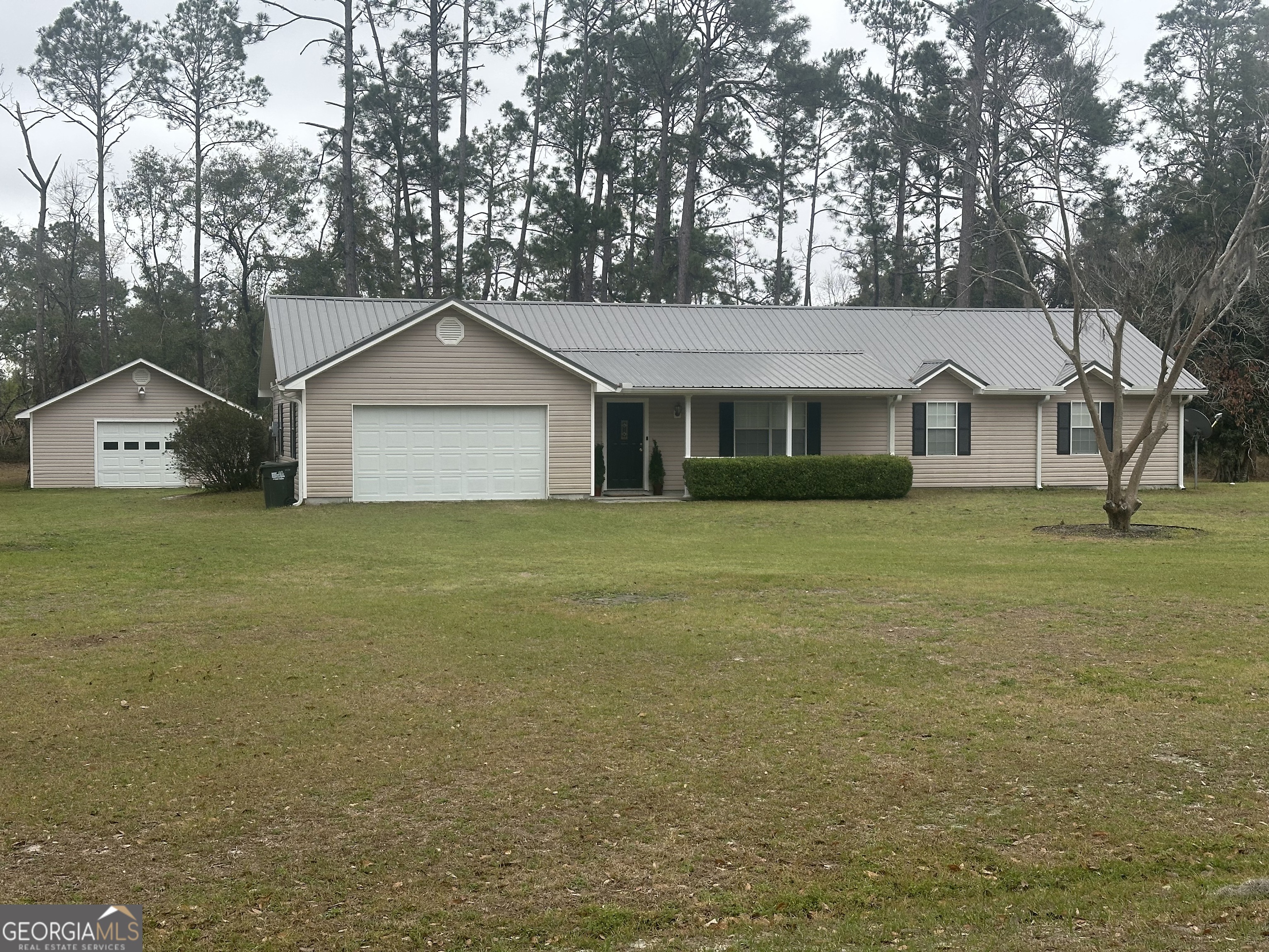 3745 Fernbank Road Valdosta, GA 31601 - Photo 1 of 1 a front view of a house with a garden and tree