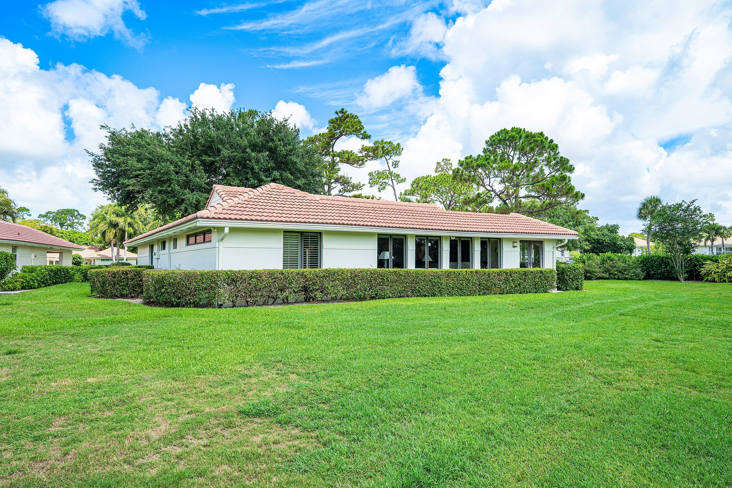 4365 Shell Drake Lane Boynton Beach, FL 33436 - Photo 28 of 56 a front view of a house with garden