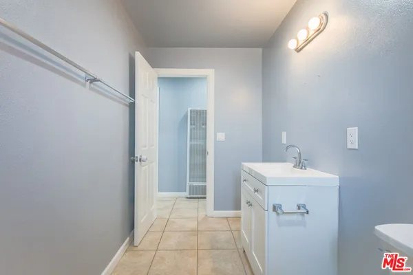 a bathroom with a sink a toilet and mirror