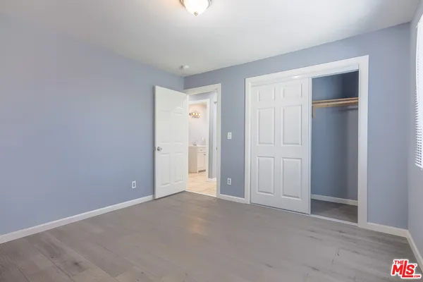 a view of an empty room and closet area