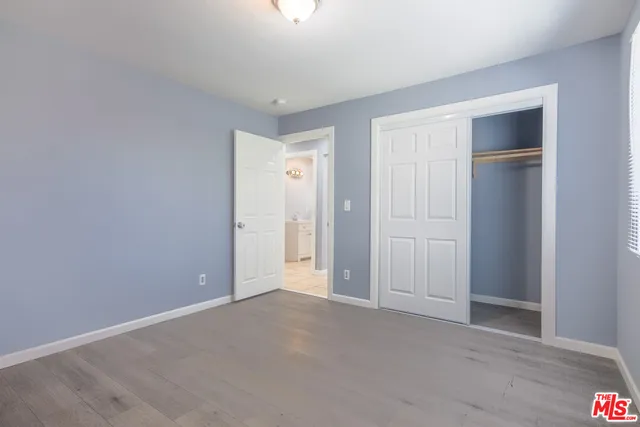 a view of an empty room and closet area