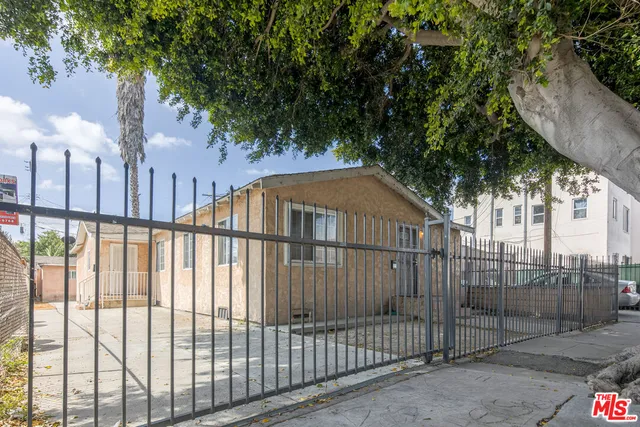 a view of a wrought iron fences in front of house