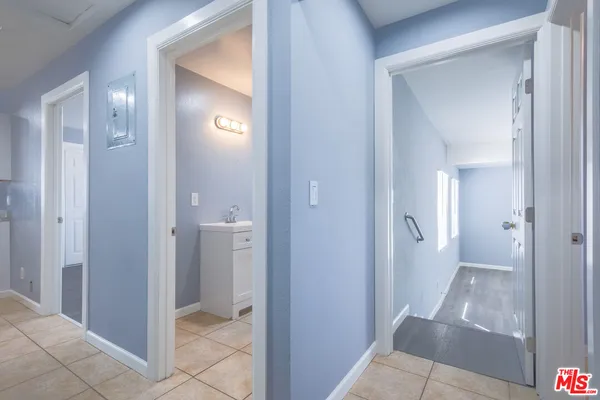 a en suite bathroom with a granite countertop vanity mirror and a sink