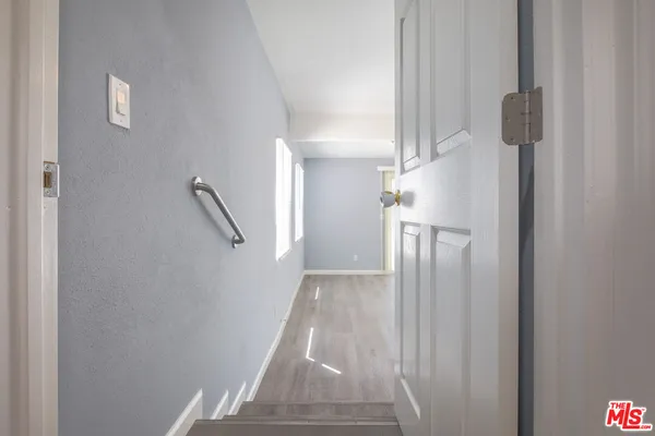 a view of entryway and hall with wooden floor