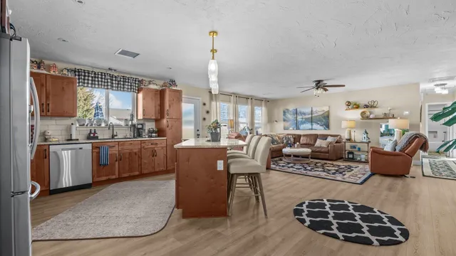 a living room with furniture and kitchen view