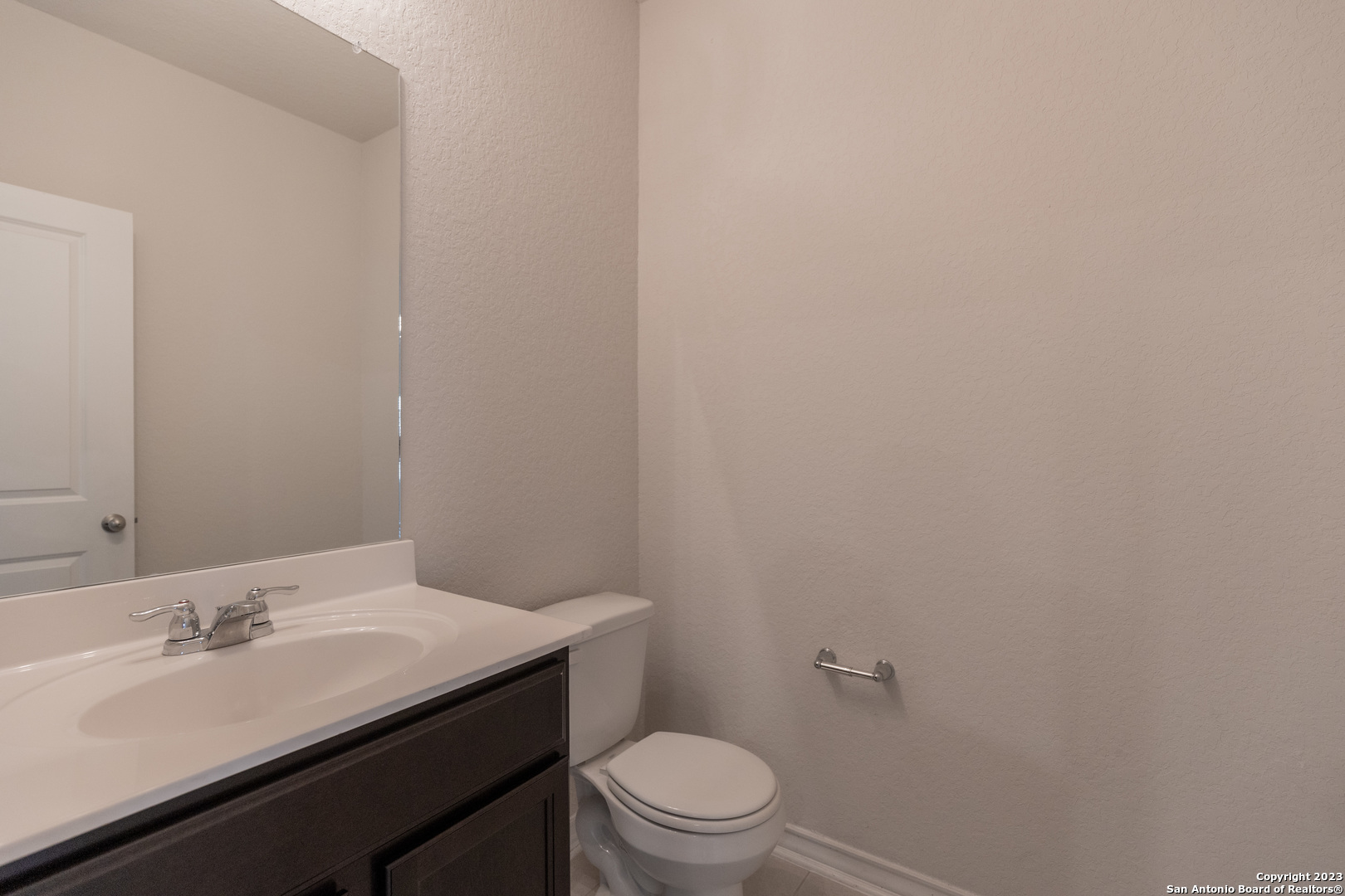 9819 Bratten Rise San Antonio, TX 78254 - Photo 12 of 37 a bathroom with a sink a toilet and a mirror