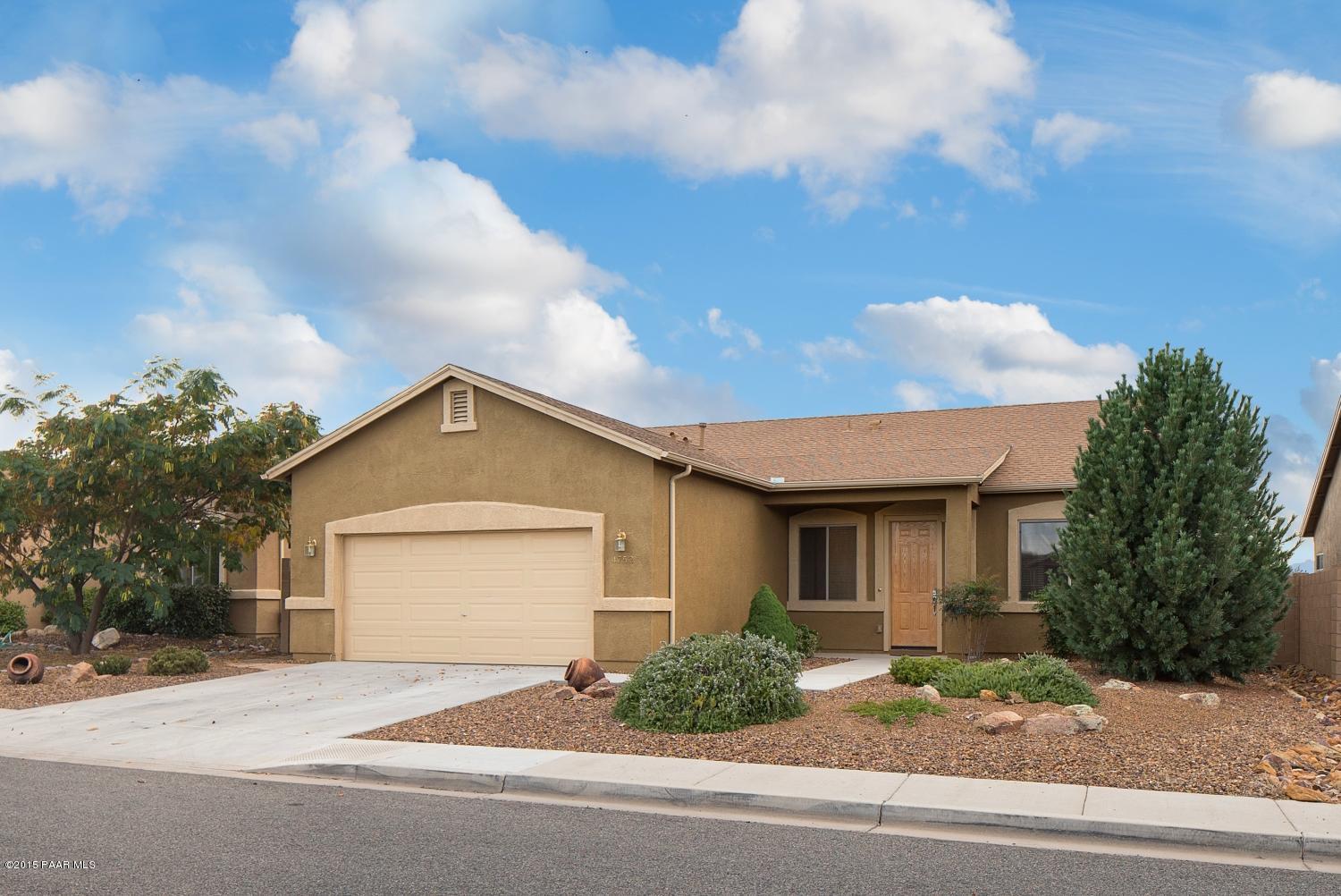 4752 Edgemont Road Prescott Valley, AZ 86314 - Photo 1 of 16 a front view of a house with a yard and garage