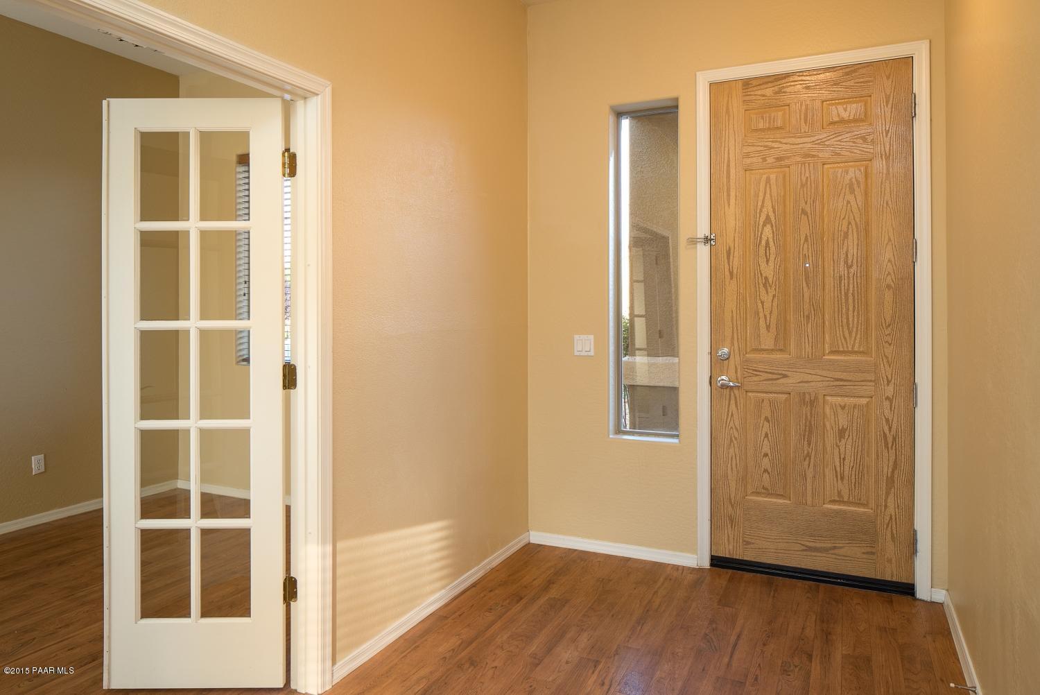 4752 Edgemont Road Prescott Valley, AZ 86314 - Photo 2 of 16 an empty room with wooden floor and windows