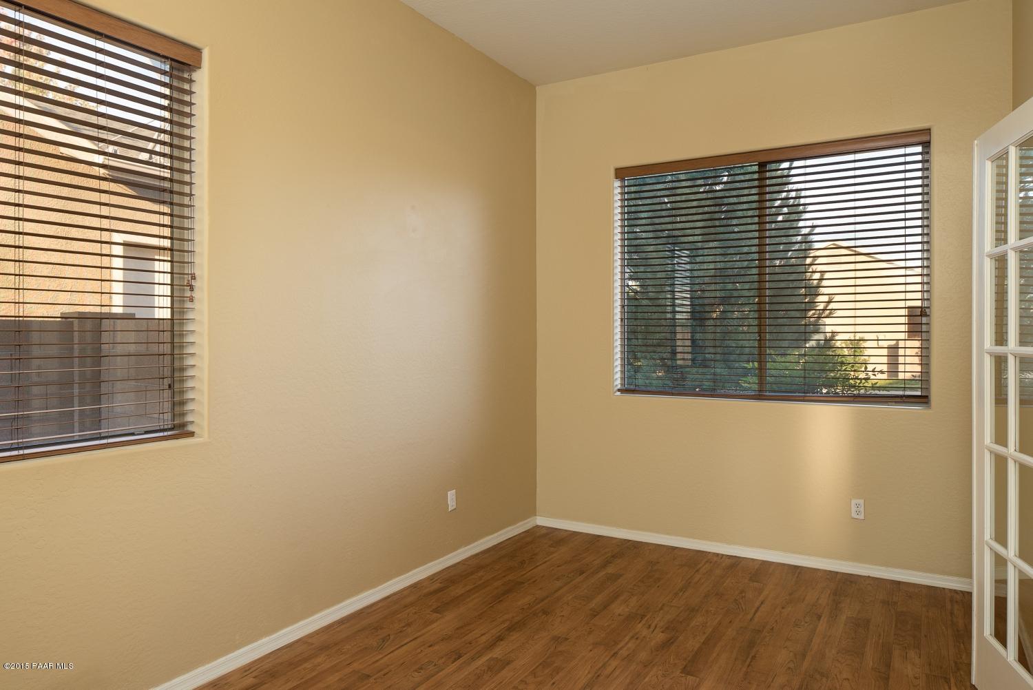 4752 Edgemont Road Prescott Valley, AZ 86314 - Photo 3 of 16 a view of an empty room with wooden floor and a window