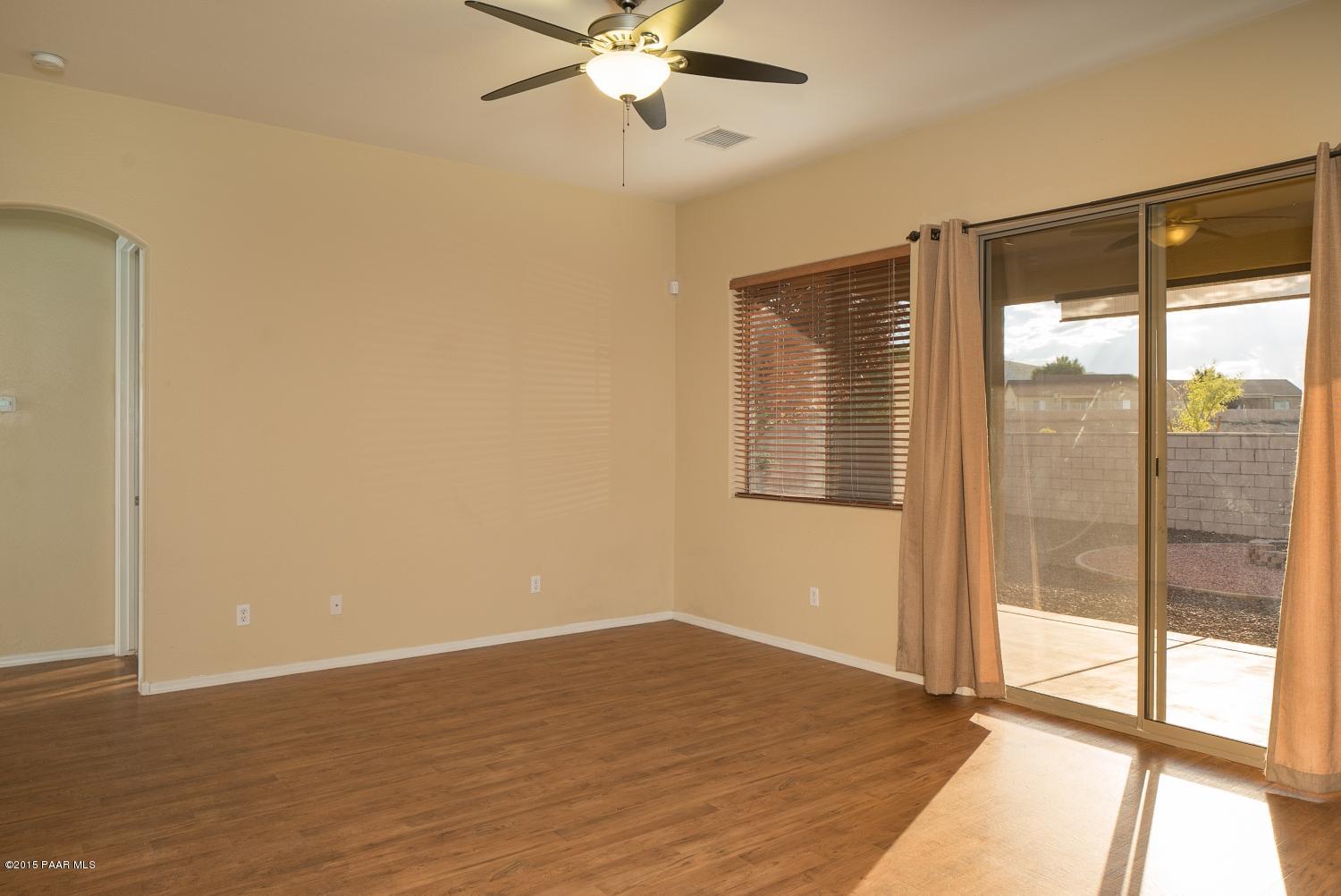 4752 Edgemont Road Prescott Valley, AZ 86314 - Photo 7 of 16 a view of an empty room with wooden floor and a window