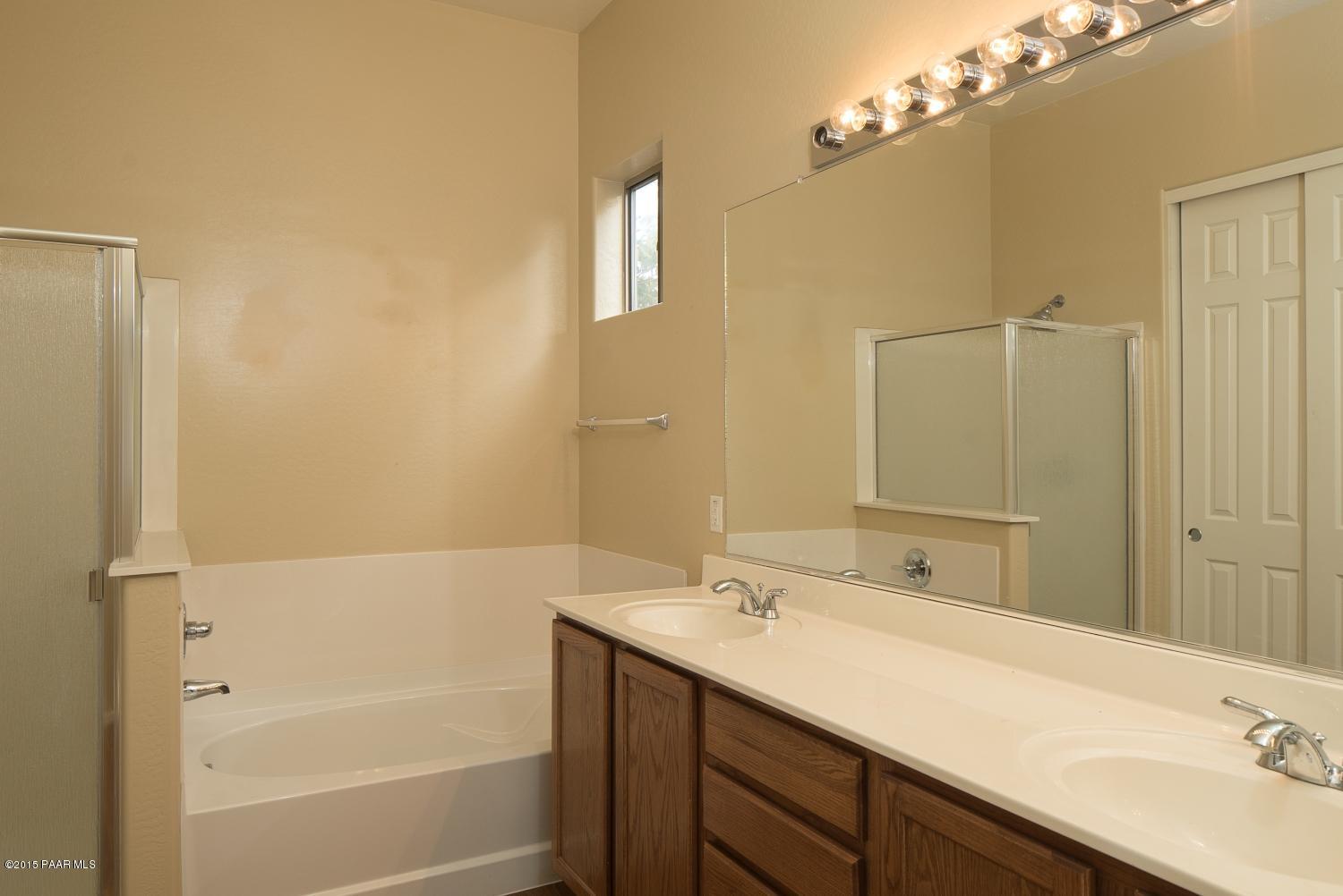 4752 Edgemont Road Prescott Valley, AZ 86314 - Photo 10 of 16 a bathroom with a tub sink double vanity and a mirror