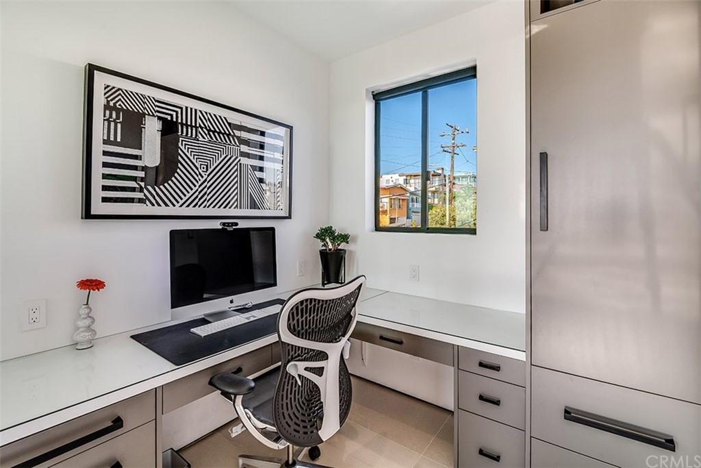 520 13th Street Manhattan Beach, CA 90266 - Photo 22 of 70 a workspace with furniture and paintings on the wall