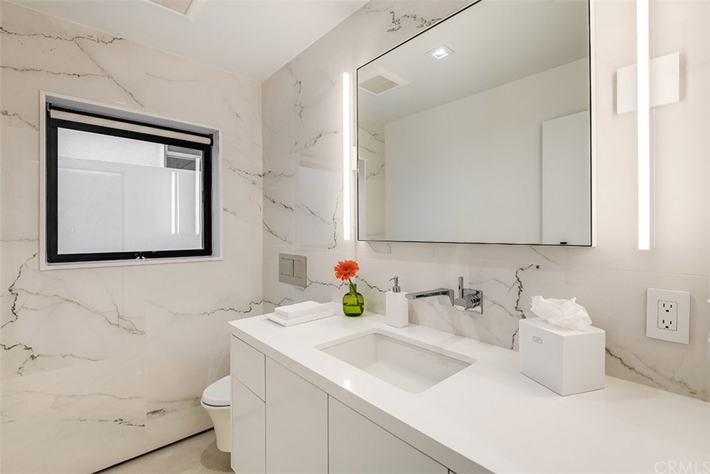 520 13th Street Manhattan Beach, CA 90266 - Photo 43 of 70 a bathroom with a sink vanity and mirror