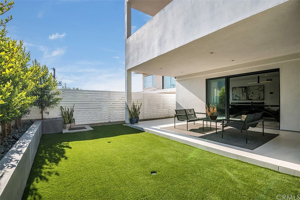 520 13th Street Manhattan Beach, CA 90266 - Photo 46 of 70 a view of a patio with table and chairs with plants and wooden fence