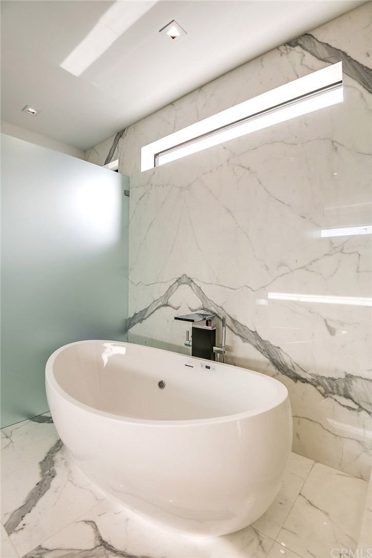 520 13th Street Manhattan Beach, CA 90266 - Photo 54 of 70 a white bath tub sitting in a bathroom