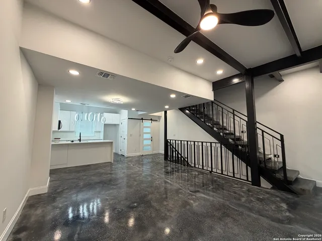 a view of a hallway with kitchen and dining table
