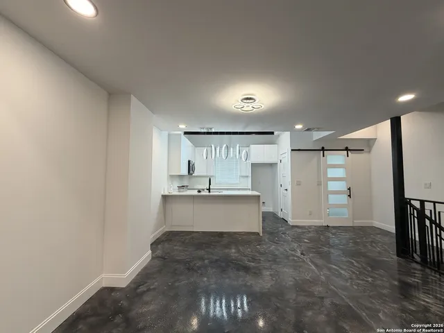 a view of a kitchen with a sink and a refrigerator