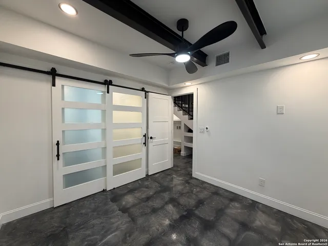 a room with cabinets and ceiling fan