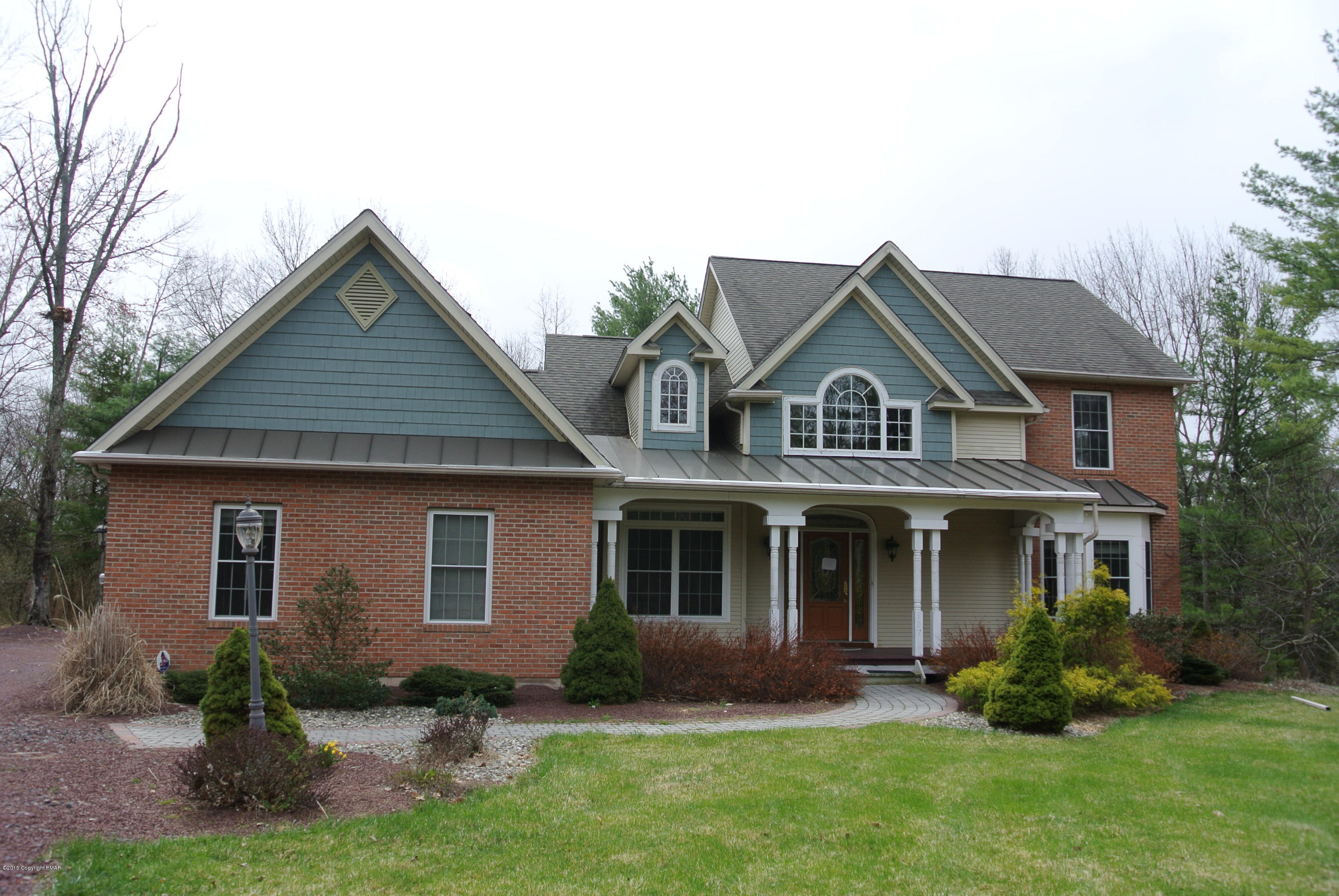 542 Quail Ridge Lane Stroudsburg, PA 18360 - Photo 1 of 12 a front view of a house with a yard and potted plants