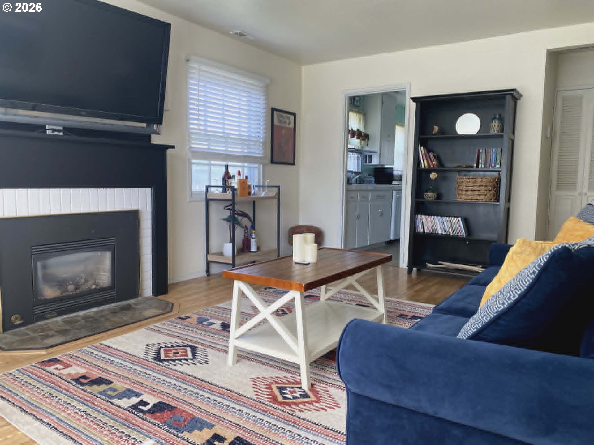 2813 Southwest Ladow Avenue Pendleton, OR 97801 - Photo 3 of 9 a living room with furniture a flat screen tv and a fireplace