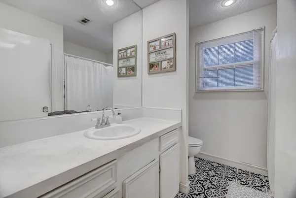a bathroom with a sink a toilet and mirror