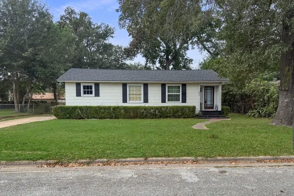 a front view of a house with a garden