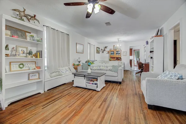 a living room with furniture and wooden floor