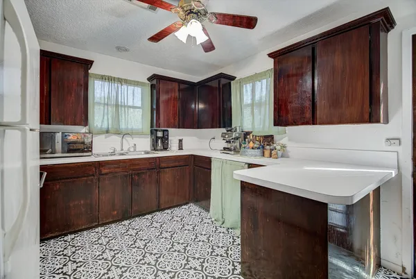 a kitchen with a sink cabinets and window