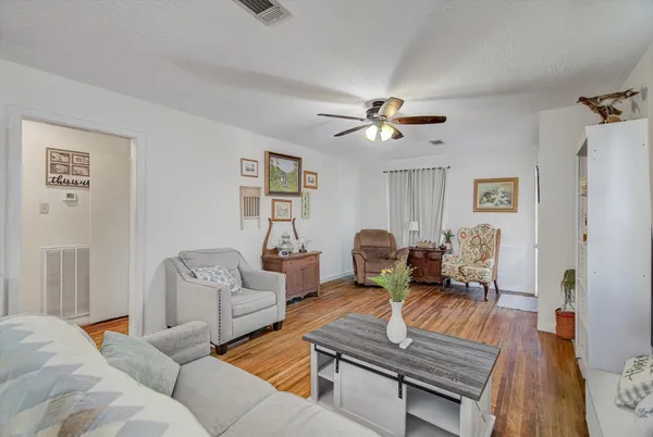 a living room with furniture two couch and a chandelier
