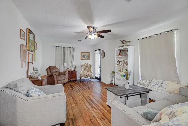 a living room with furniture and wooden floor