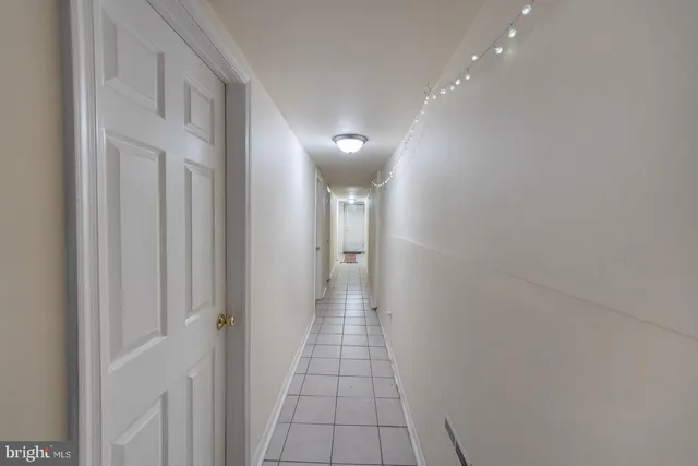 a living room with furniture a couch and a coffee maker with wooden floor