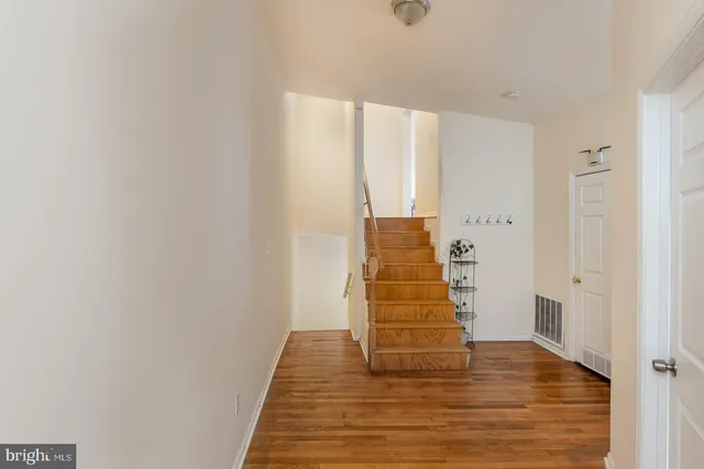 a view of a hallway with wooden floor
