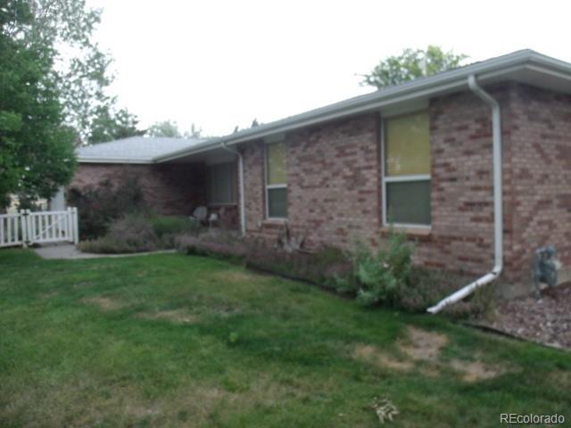 2372 Haskell Way Watkins, CO 80137 - Photo 4 of 17 a brick house with a small yard