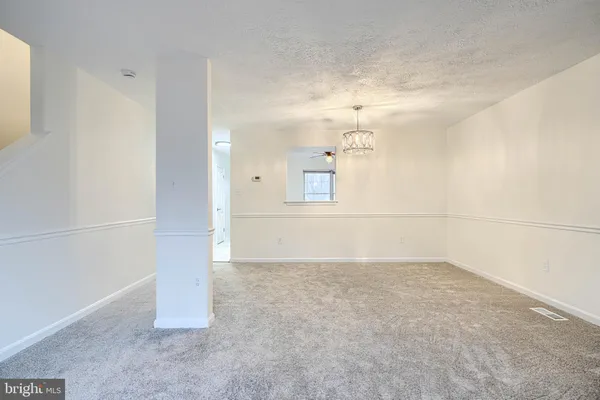 an empty room with cabinet and mirrors