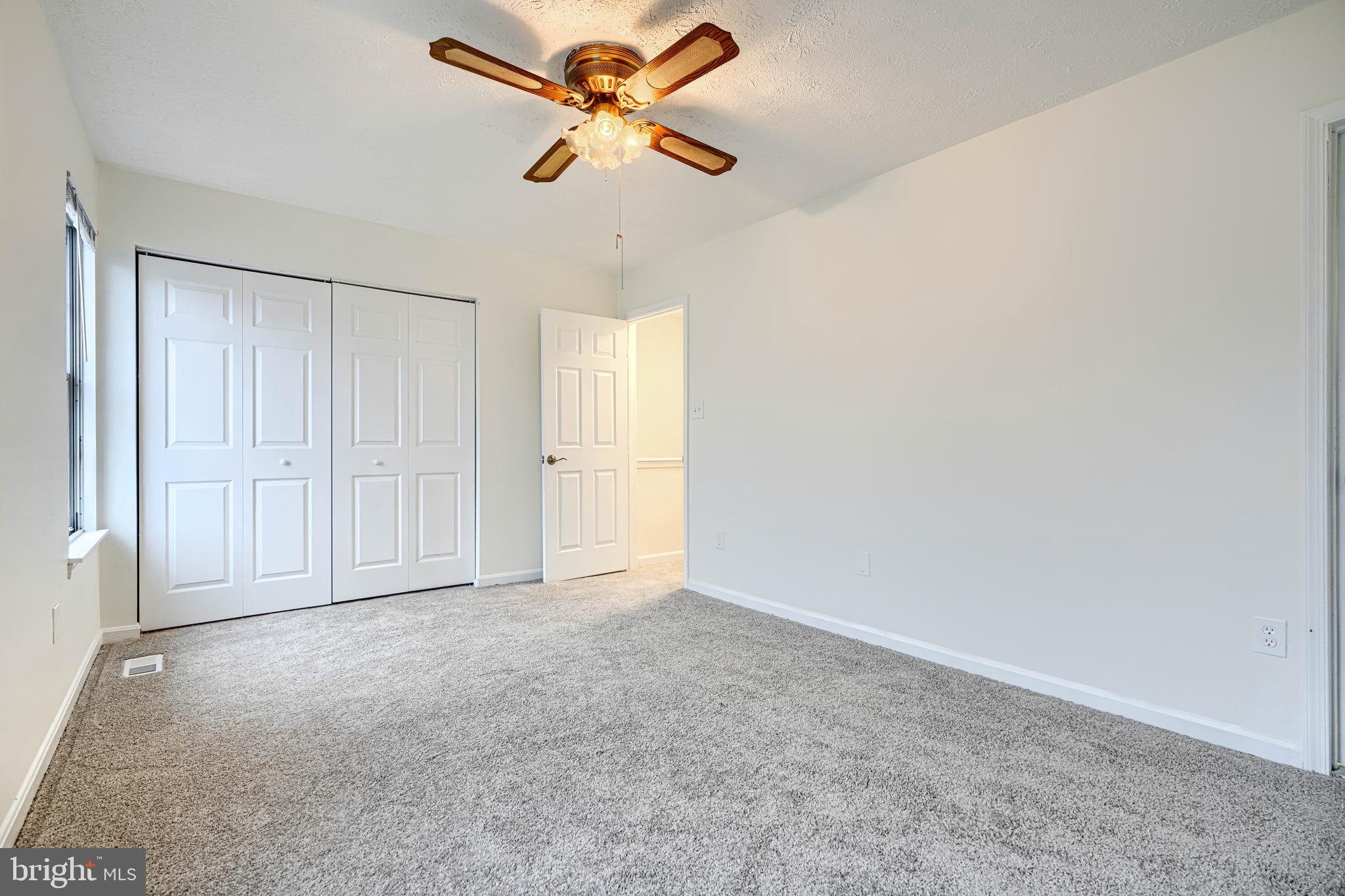 11 Offspring Court Perry Hall, MD 21128 - Photo 22 of 38 an empty room with closet and a chandelier fan