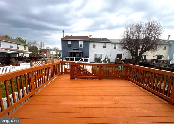 a view of a house with backyard and deck