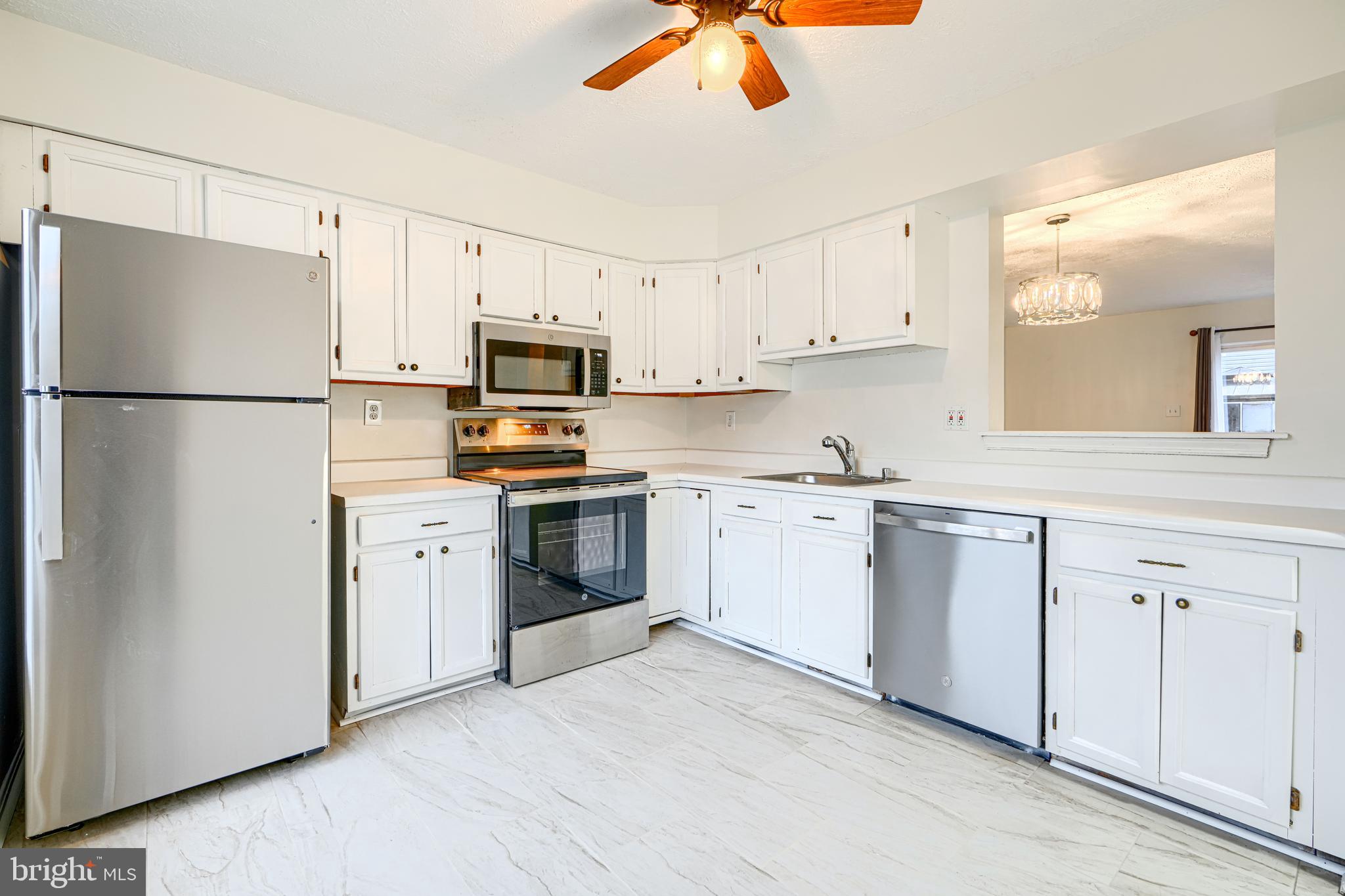 11 Offspring Court Perry Hall, MD 21128 - Photo 5 of 38 a kitchen with cabinets stainless steel appliances and a refrigerator