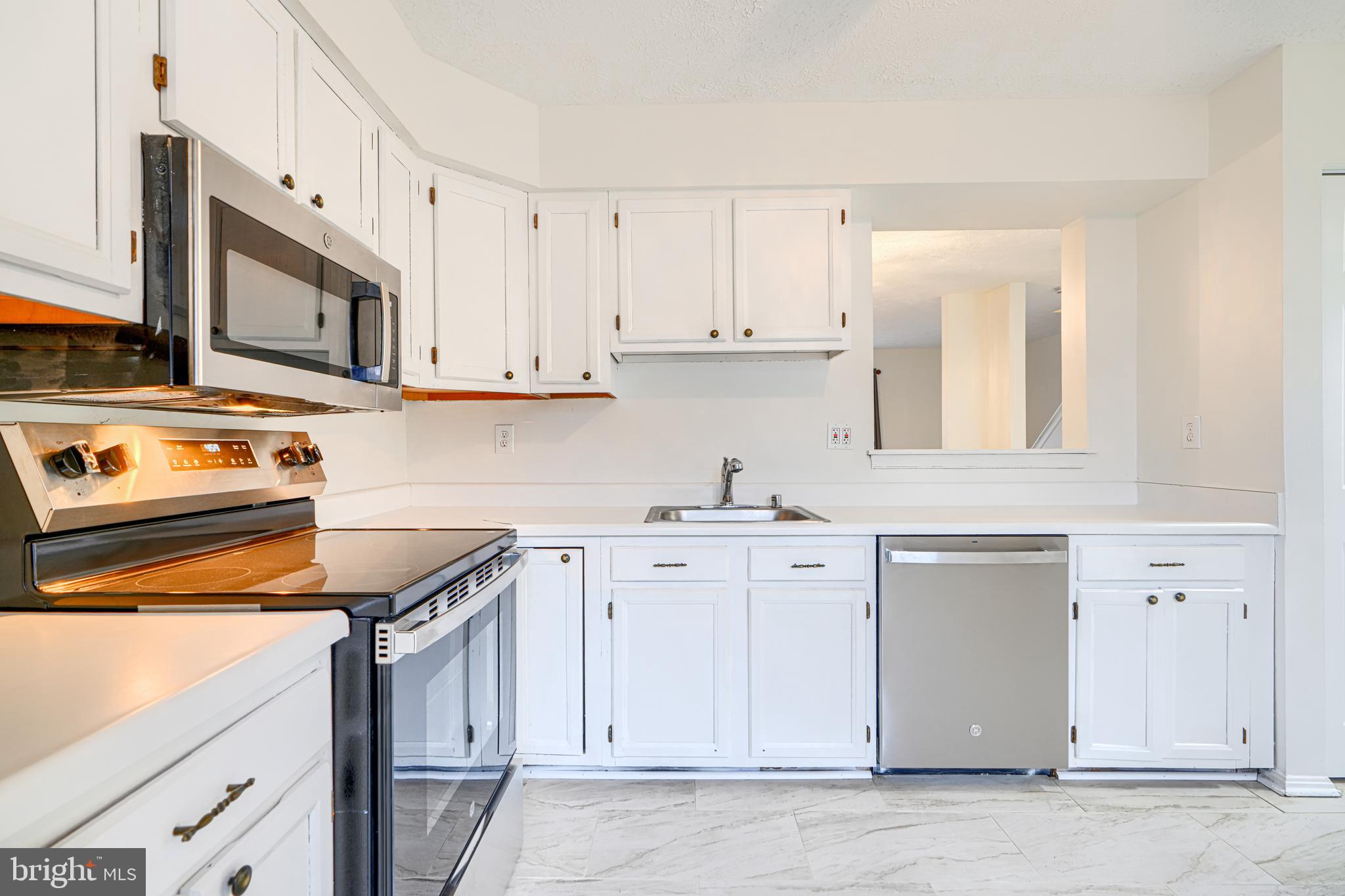 11 Offspring Court Perry Hall, MD 21128 - Photo 6 of 38 a kitchen with granite countertop white cabinets and white appliances