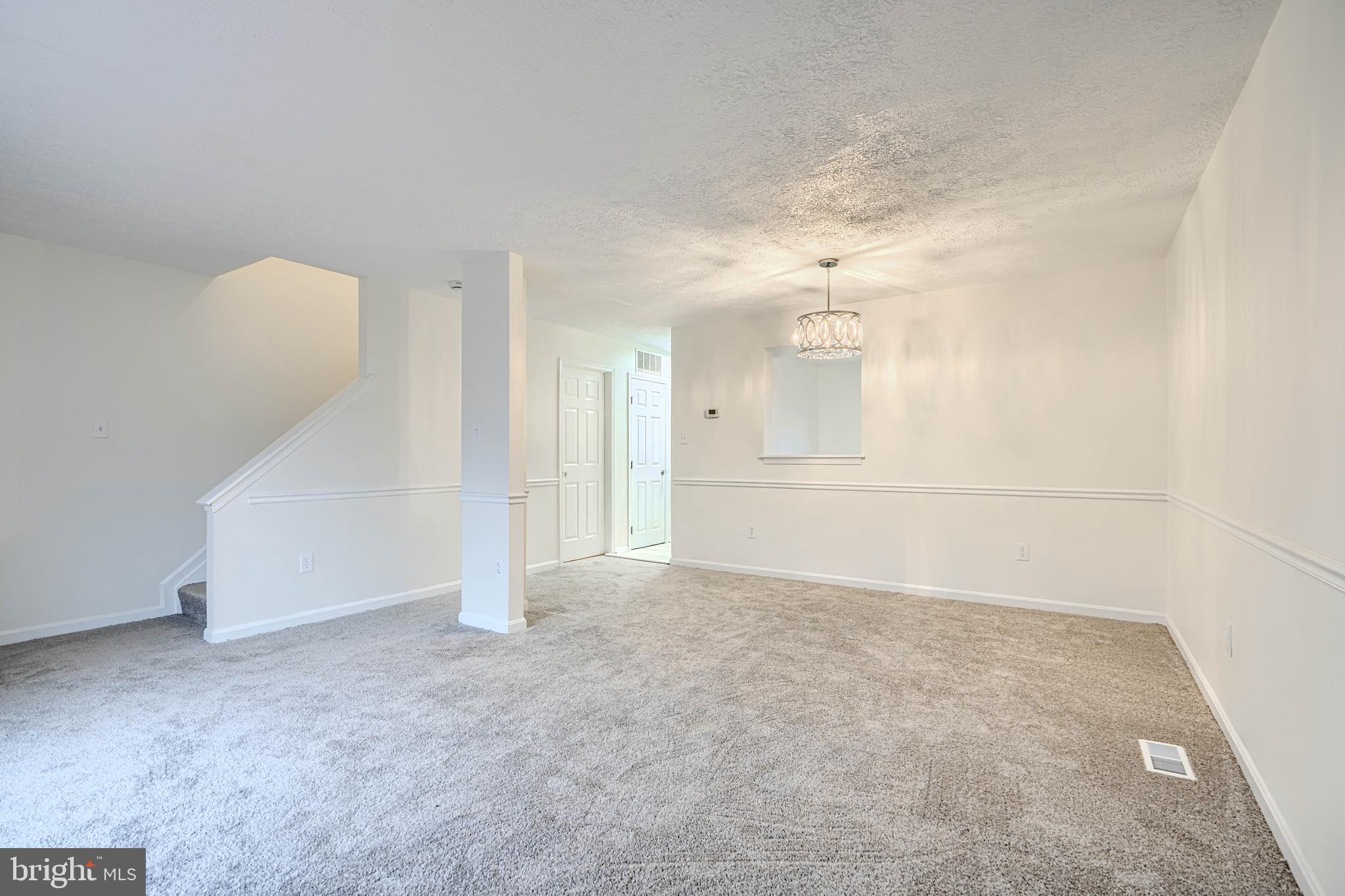 11 Offspring Court Perry Hall, MD 21128 - Photo 10 of 38 an empty room with chandelier fan and windows